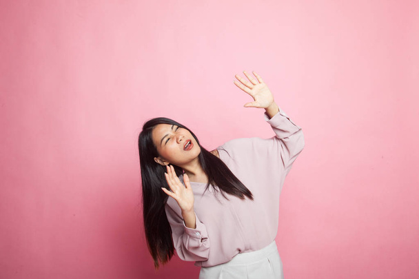 Excited young Asian woman look up on pink background - Foto, Imagem