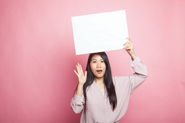 Young Asian woman surprise with white blank sign on pink background - Zdjęcie, obraz