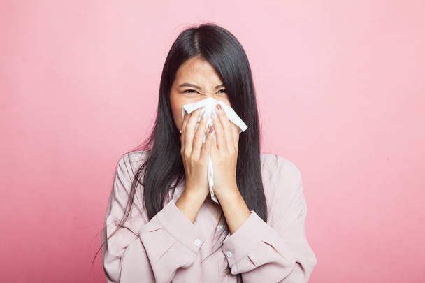 Young Asian woman got sick and flu on pink background - Foto, afbeelding