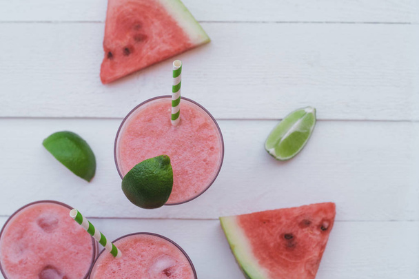 Smoothies of fresh watermelon, lime with ice on a white table. Top view - Foto, imagen