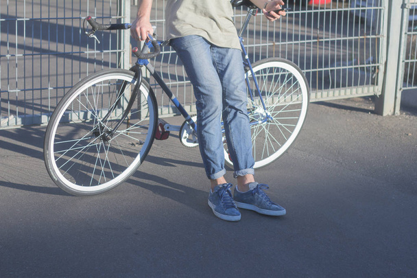 Young ,man walk with fixie bike, urban background, picture of hipster with bicycle in blue colors - Φωτογραφία, εικόνα