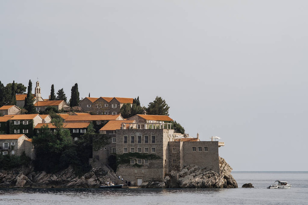 View on the old town on the Sveti Stefan Island in Montenegro. Balkans, Adriatic sea. - Zdjęcie, obraz