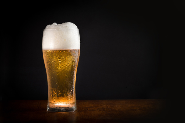 Glass of fresh cold chilled beer with black background - Foto, Imagen