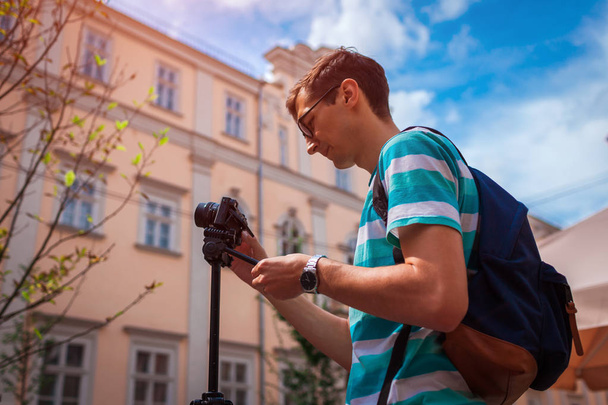 Portrét šťastný mladý muž, turisté s přijetím fotoaparát obrázky starého města při západu slunce v létě - Fotografie, Obrázek