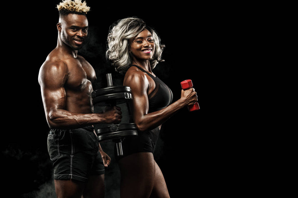 Fitness couple of athletes posing on black background, healthy lifestyle body care. Sport concept with copy space. - Photo, Image