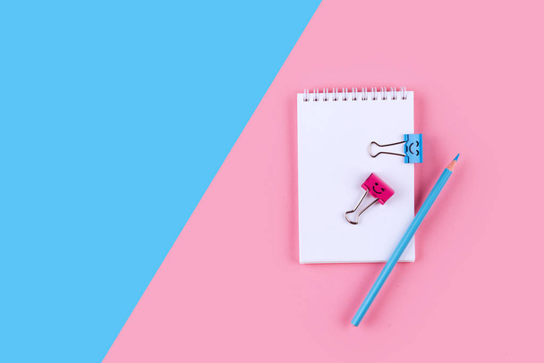 Top view of Blank notebook on colorful background pink blue with copy space. - Fotó, kép