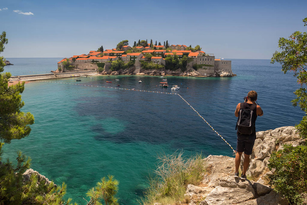 Il fotografo fa una foto Isola di Sveti Stefan a Budva, Montenegro
. - Foto, immagini