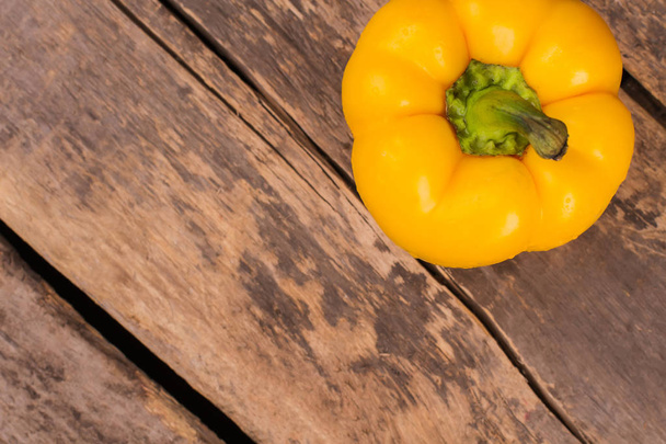 Juicy beautiful Bulgarian pepper on a wooden background. - Φωτογραφία, εικόνα