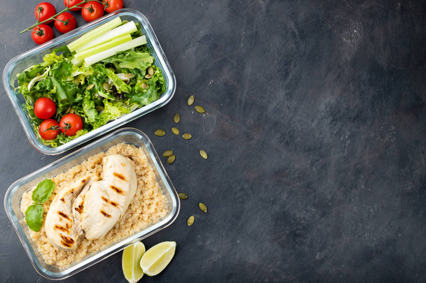 Healthy meal prep containers with quinoa, chicken breast and green salad overhead shot with copy space. Top view. Flat lay. - Photo, Image