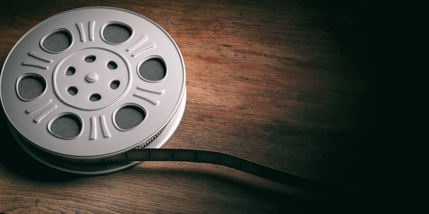 Cinematography concept. Film movie reel, isolated on a wooden background, copy space, 3d illustration. - 写真・画像