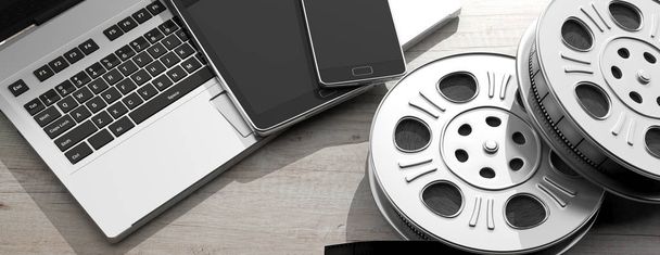 Cinematography and electronic devices. Film movie reels, laptop, tablet and smartphone, on a white wooden background, 3d illustration. - Photo, Image