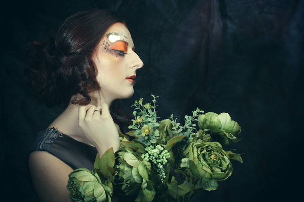 close up portrait redhair woman with bright creative make up holding dry flowers - Φωτογραφία, εικόνα