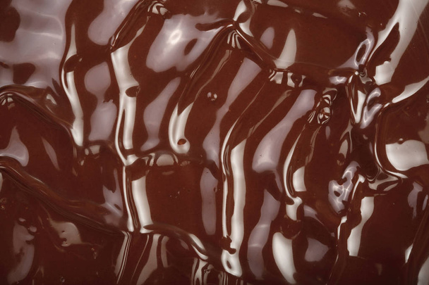 Λιωμένη σοκολάτα στροβιλισμού ως ένα closeup του φόντου - Φωτογραφία, εικόνα