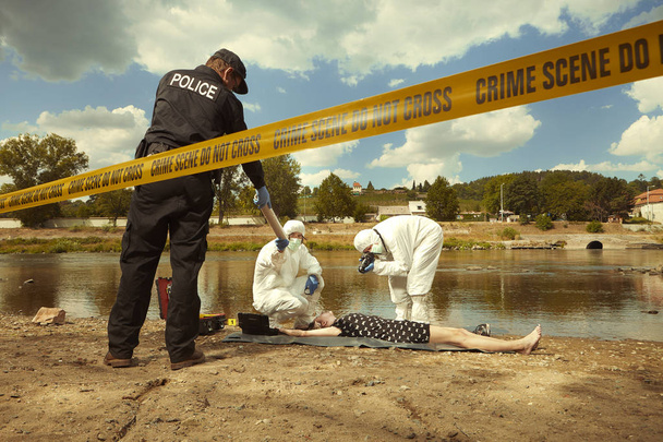 Woman body in black apparel found drowned near summer river bank in city - Foto, Bild