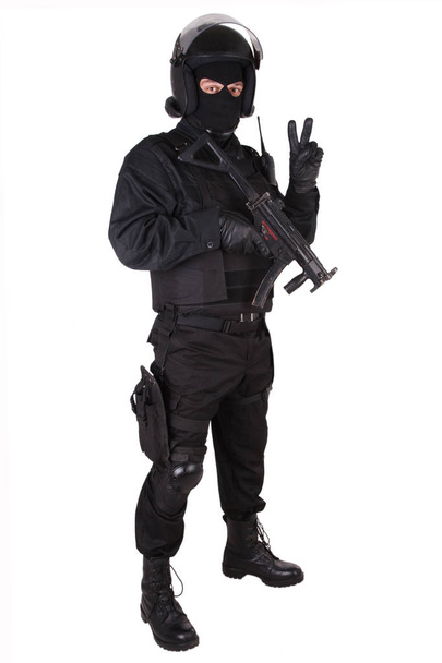 Riot police officer with weapon in black uniform isolated on white - Photo, Image