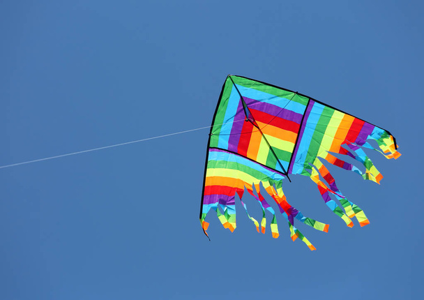 великий барвистий повітряний змій літає високо в небі
 - Фото, зображення
