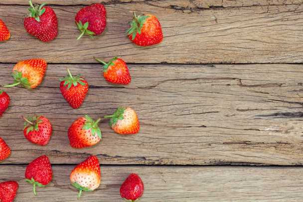 strawberries on the old wooden table background - 写真・画像