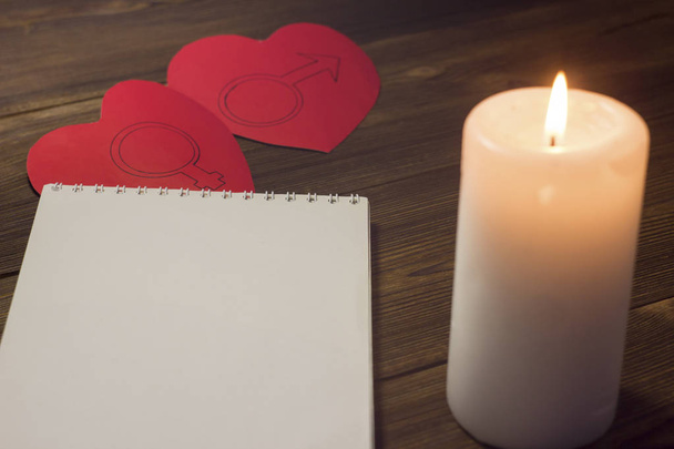 Candle blocks and two hearts candle on a wooden background - Foto, Imagen