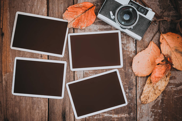 Retro camera with paper photo frame for add picture. memories and nostalgia in fall (Autumn) concept. vintage color effect. - Photo, Image