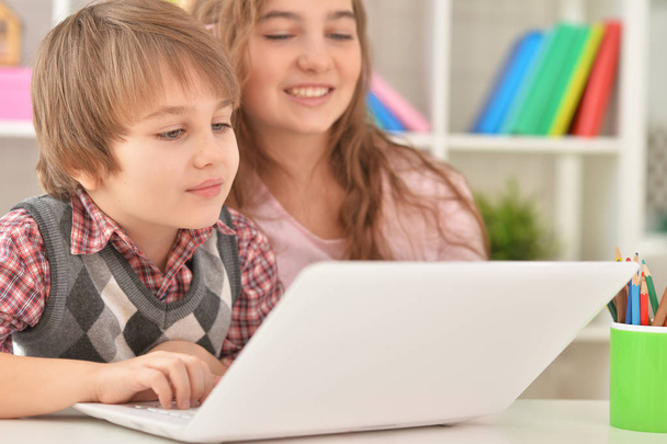 Boy and girl using laptop - Photo, image