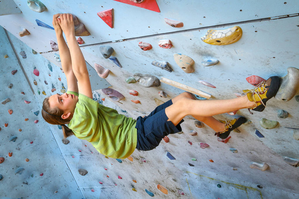Teenage Boy Training Climbing On Indoor Climbing Wall - Foto, Imagen
