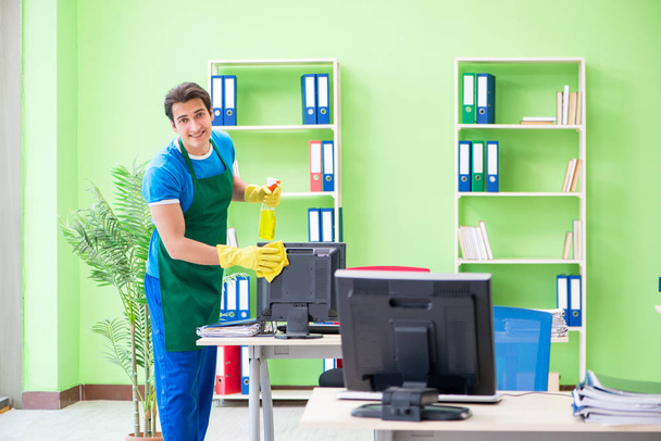 Mies komea ammatillinen siivooja työskentelee toimistossa - Valokuva, kuva
