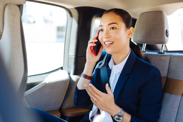 Nice smart businesswoman having a phone conversation - Foto, afbeelding