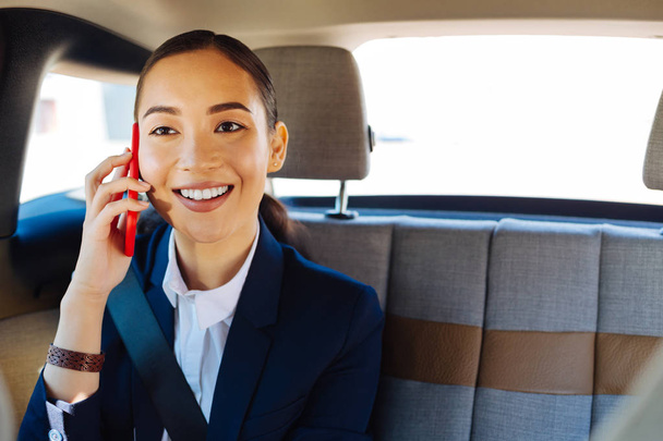 Joyful attractive businesswoman having a phone conversation - Photo, Image