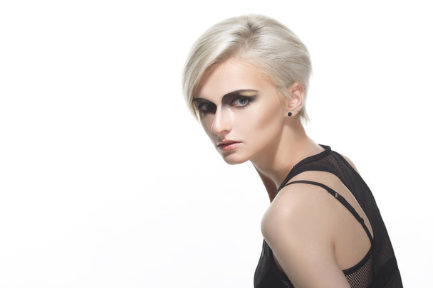 Portrait of blonde woman with short haircut and dramatic makeup isolated on white background. - Foto, afbeelding
