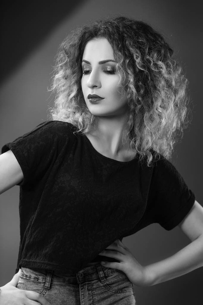black and white portrait of woman with curly hair in style of glam rock - Fotó, kép