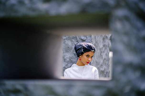 Portrait of a young Muslim woman (Islam) wearing a turban (headscarf, hijab).  She is elegant, attractive  - 写真・画像