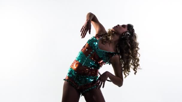 amazing dancing sexy woman dances in a sparkling costume against white background - Footage, Video