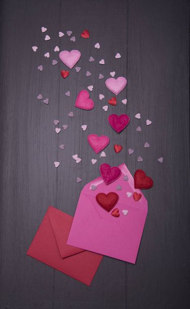 envelopes with colorful hearts on wooden background, Valentines day concept - Photo, image