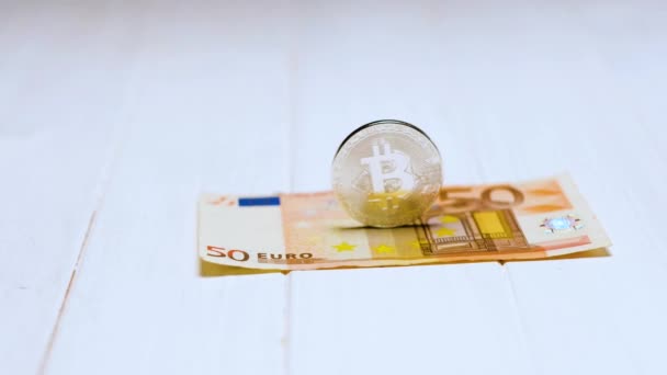 Bitcoins and banknote on white table - Πλάνα, βίντεο