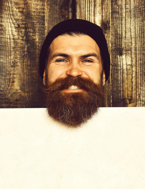 Bearded brutal caucasian hipster with white paper sheet - Fotó, kép