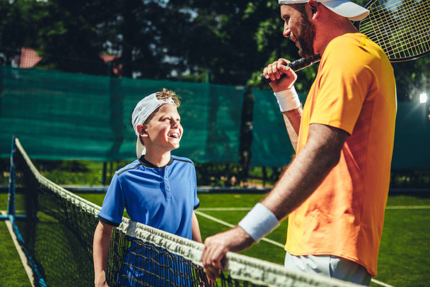 Happy male talking with kid on court - Foto, Imagem