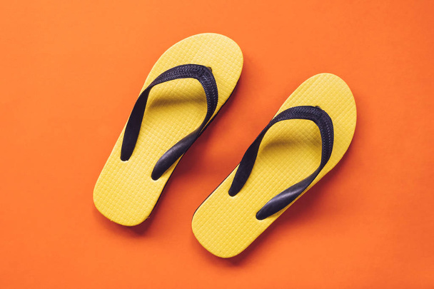 Top view of Yellow flipflop on orange background - Photo, Image