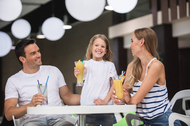 Happy family having cold drinks in department store - Фото, зображення