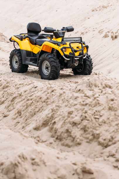 modern yellow all-terrain vehicle standing in desert - Foto, Bild