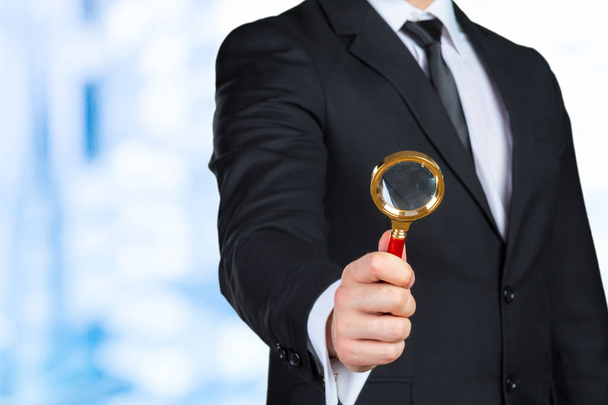 business man holding magnifying glass concept - Foto, afbeelding
