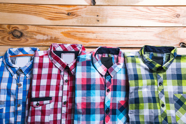 shirts plaid in plan with wooden background - Фото, изображение