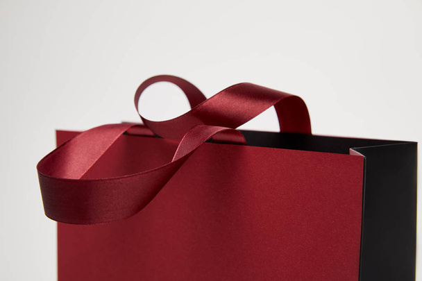 selective focus of one burgundy shopping bag isolated on white - Fotoğraf, Görsel