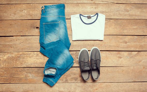 Outfit of casual man on wooden background, close-up  - 写真・画像