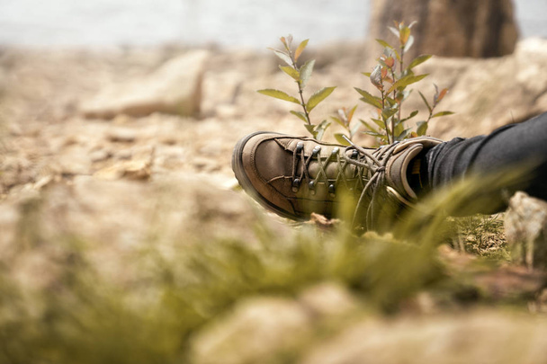 walking shoes during a break on a hike in the mountains while climbing - Foto, Imagen