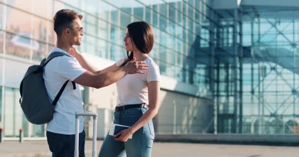 Attractive couple in love, saying goodbye near airpotr or train station. Concept of departure, farewell, business trip. Summer time, sunset - Filmati, video