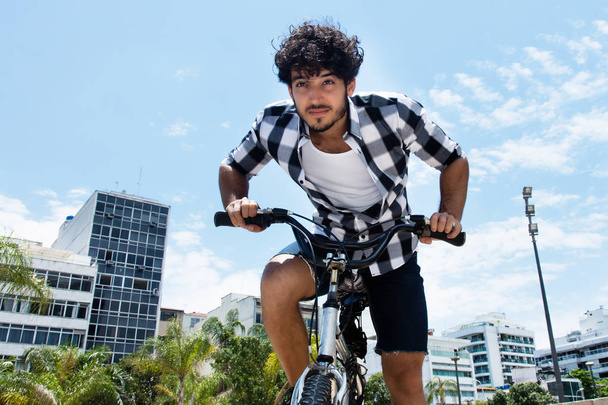 Man riding bike outdoor in the city in the summer - Fotoğraf, Görsel