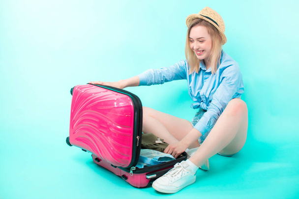 young woman opening her suitcase after holidays - Fotoğraf, Görsel