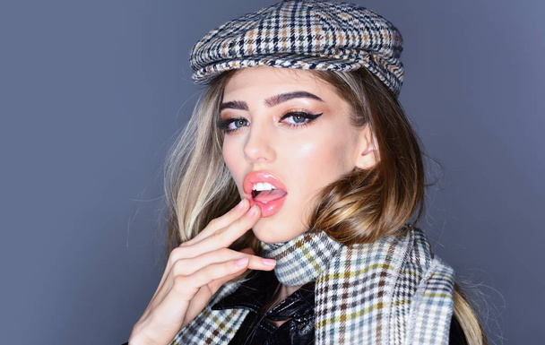 Fashion studio photo of young stylish woman on grey background. scarf and hat - Photo, Image
