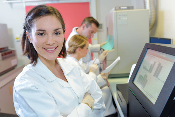 medical scientists using digital machinery at laboratory - Фото, изображение