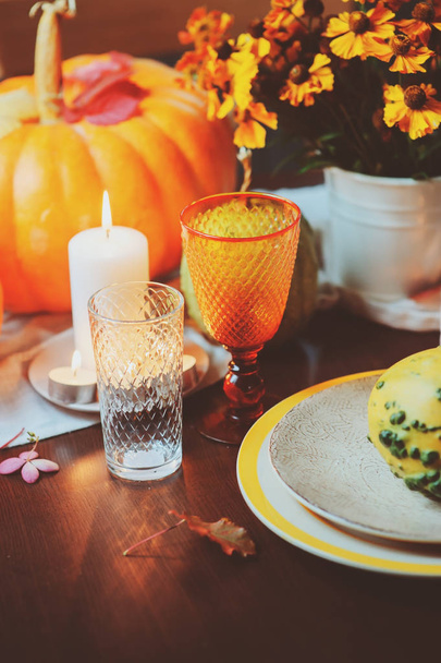 autumn traditional table setting for Thanksgiving or Halloween, with candles squash and pumpkins. - Fotó, kép